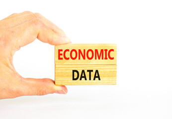 Economic data symbol. Concept words Economic data on wooden block. Beautiful white table white background. Businessman hand. Business economic data concept. Copy space.