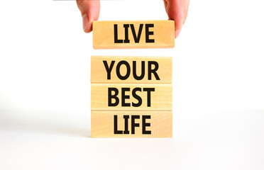 Live your best life symbol. Concept words Live your best life on wooden blocks. Beautiful white table white background. Businessman hand. Business live your best life concept. Copy space.