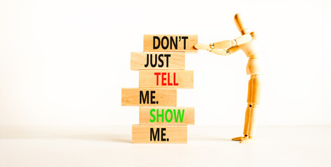 Tell or show symbol. Concept words Do not just tell me, show me on wooden blocks. Beautiful white...