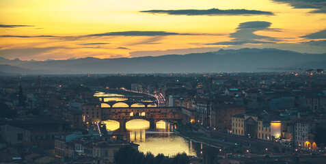 River Arno with bridge Ponte Vecchio during the sunset in Florence, Italy