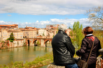 Senior couple admiring river view in medieval town of Albi, Roussillon-Languedoc, France....