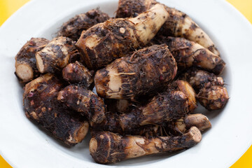 Organic taro fruit in white plate
