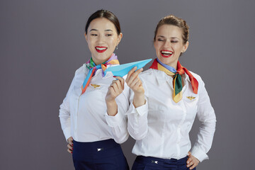 smiling elegant air hostess women isolated on grey