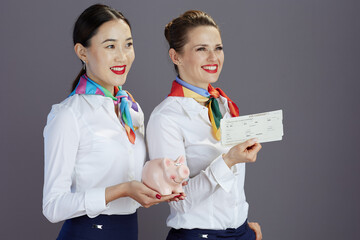 happy stylish flight attendant women isolated on gray