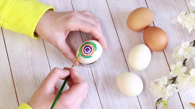 Paint Easter eggs with bright colors, top view. Master class on painting eggs for the holiday. Easter