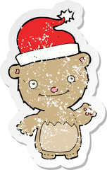 retro distressed sticker of a cartoon christmas teddy bear