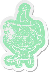 cute cartoon distressed sticker of a dog wearing santa hat