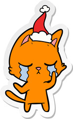 crying sticker cartoon of a cat wearing santa hat