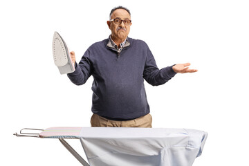 Confused mature man ironing a shirt
