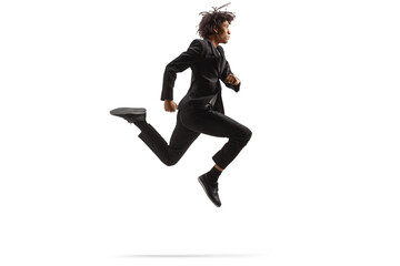 Full length profile shot of an african american man in a black suit jumping
