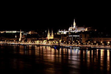 Fototapeta na wymiar Matthias Church, Fisherman's Bastion and the night lights of the Danube bank, Budapest, Hungary