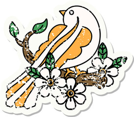 traditional distressed sticker tattoo of a bird on a branch