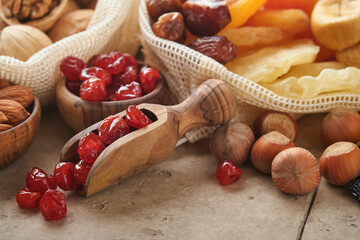 Tu Bishvat celebration concept Mix of dry fruits and almonds, hazelnuts, walnuts, apricots, prunes, cherries, raisins, dates, apples, figs on old tile table background Jewish holiday new year of trees