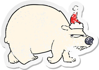 distressed sticker cartoon of a angry polar bear wearing santa hat