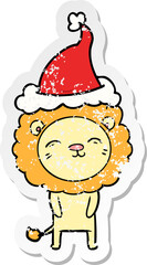 distressed sticker cartoon of a lion wearing santa hat