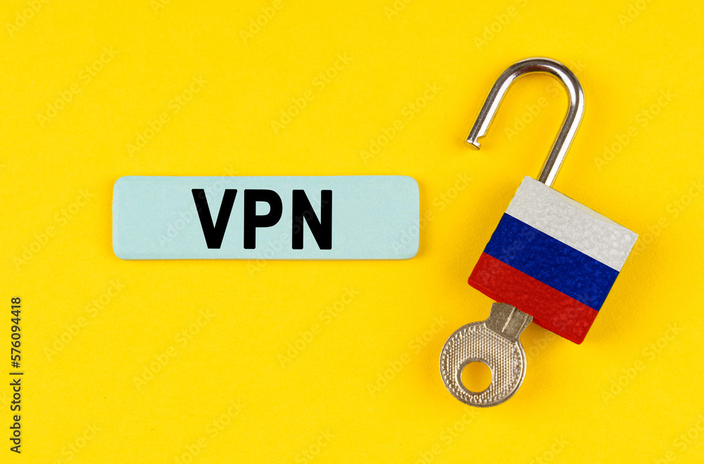 Poster on the yellow surface is an open lock with a key and a sticker with the inscription - vpn