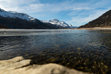 View over the frozen lake of Silvaplana and the peak of the mount Corvatsch in the background