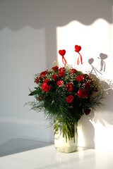 red roses and hearts in the vase - 576097805