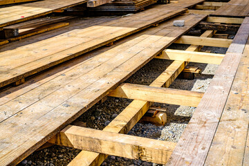 heap of wooden planks at a construction site