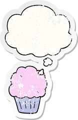 cartoon cupcake and thought bubble as a distressed worn sticker