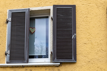 a window with dark brown shutters
