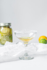 Lime cocktail in a coupe glass, citrus cocktail on  a white table