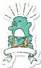 grunge sticker of tattoo style penguin sitting on present