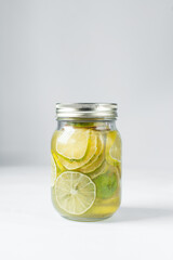 Lime in sugar syrup in a mason jar, Lime syrup for making tea, Lime slices in a sugar syrup