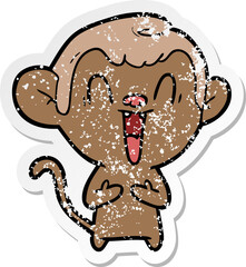 distressed sticker of a cartoon laughing monkey