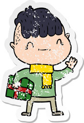 distressed sticker of a cartoon friendly boy with christmas present