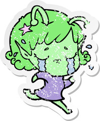distressed sticker of a cartoon crying alien girl