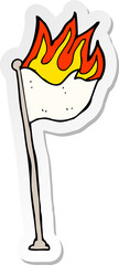sticker of a cartoon burning flag on pole