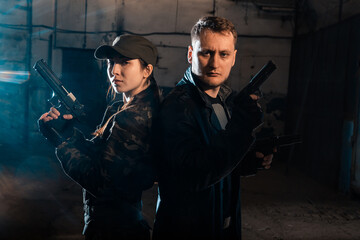 Fototapeta premium A person with a weapon. Character from the comic book The Punisher. Armed with a pistol and machine gun. A dangerous person who solves problems with force.