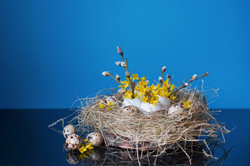 Happy Easter background concept. Easter decoration as nest with egg shells with spring flowers and quail eggs. Creative easter layout. Copy space
