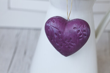 Purple Heart Hanging Across White Still Life - 576119445
