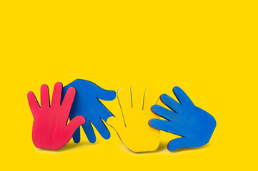 Colorfull puzzles hands on blue background. World Autism Awareness Day Concept