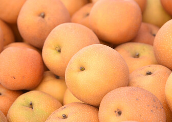 Close up top view of super sweet Asian Pears piled up for sale at Farmers Market