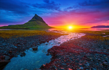 An incredible view of the famous peak of the Kirkjufell volcano at dawn. Iceland, Europe.