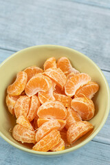 Tangerines in the bowl above dark blue food backgrounds