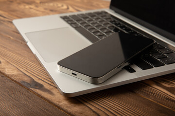 Open laptop with digital tablet and smartphone on the office table. Office workplace with text space. top view, flatley. MOCAP. Technology concept.