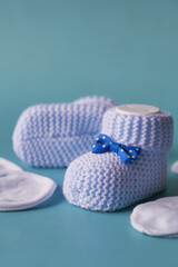Obraz na płótnie Canvas blue color Knitted shoes for an infant. 
