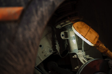 Replacement and repair of wheels and shock absorbers on a car in a garage