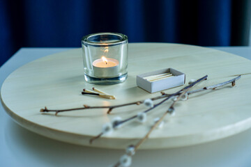 Cozy home interior with a burning tea light.