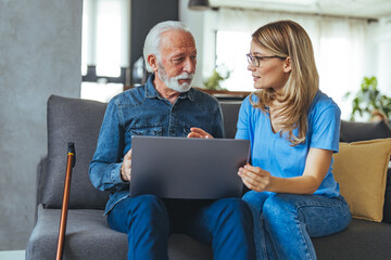 Female nurse consulting his senior male patient while sitting on sofa during the day. Active senior...