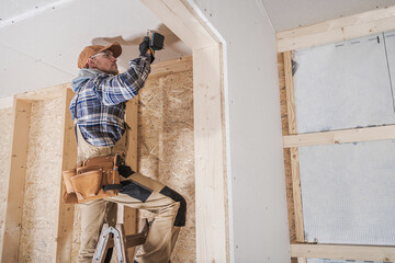 General Construction Contractor Worker Attaching Drywall Using Drill Driver - obrazy, fototapety, plakaty