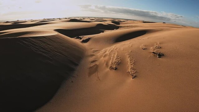 FPV aerial scene of the Maspalomas Dunes in Playa del Ingles, Maspalomas on the island of Gran Canaria in Spain. Flying an FPV drone over the dunes.