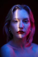 Beauty portrait of a woman with natural skin posing isolated on magenta background with photo gels. Viva magenta, color of the year.