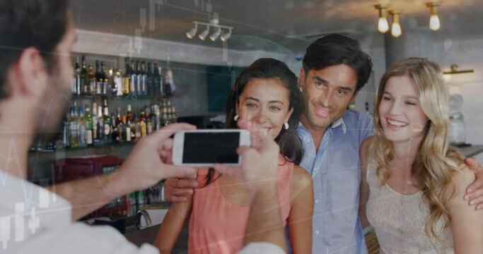Animation of data processing over caucasian male waiter taking picture of group of friends at a bar