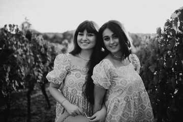 Fototapeta na wymiar Pretty girls. The girls pose in the vineyard.