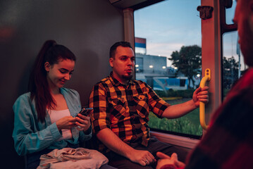 Friends talking while riding a bus in the city